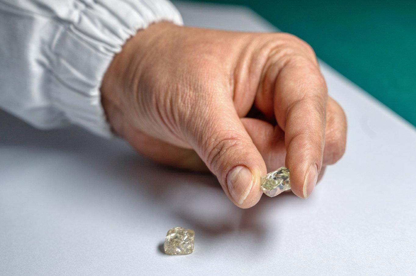 Big diamond in hand. Natural rough diamonds